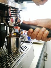 Hand holding coffee cup at cafe