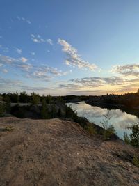 Scenic view of land against sky during sunset