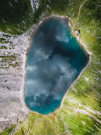 Aerial photo of clouds reflecting in alpine lake, obertauern, salzburg, austria