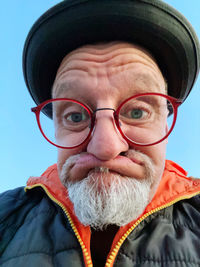 Close-up portrait of older  man wearing hat