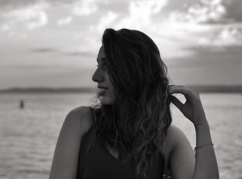 Portrait of woman against sea against sky