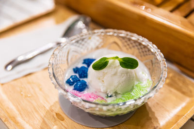 Thai dessert delicious coconut milk ice with salim and blue tub tim krob on wooden plate