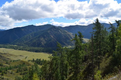 Scenic view of mountains against cloudy sky