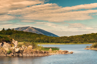 Scenic view of lake and mountains against sky