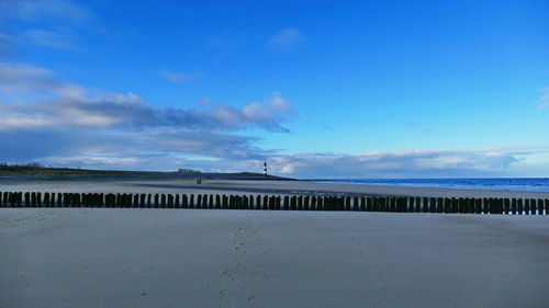 Scenic view of beach against blue sky