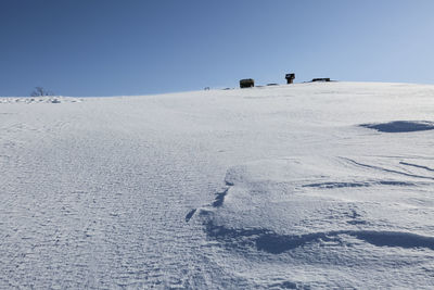 Scenic view of land against clear sky during winter