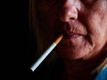 Close-up of mature woman smoking cigarette