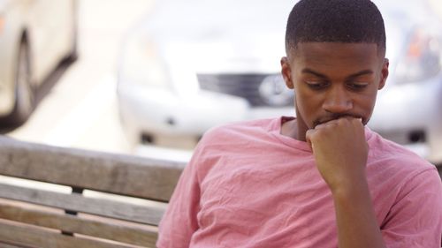 Close-up of thoughtful man sitting on bench