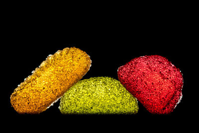 Close-up of multi colored candies against black background