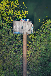 Drone shot of the wooden pier, canoe, sup and the lake in mazury, poland.