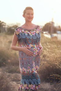 Low section of woman standing on field