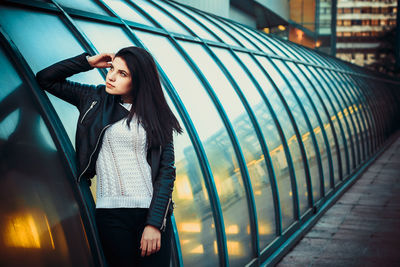 Young woman standing on street in city