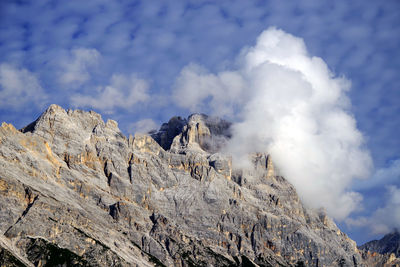 Low angle view of rocky mountains against sky