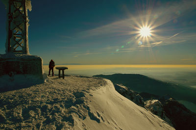 Scenic view of snow covered land against sky during winter