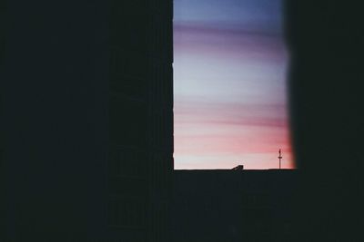 Low angle view of built structure against sky at sunset