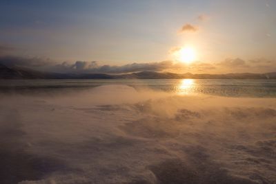 Scenic view of beach against sky during sunset