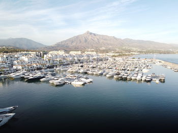 Aerial view of sea and mountains against sky