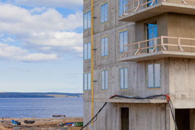 Building by sea against sky