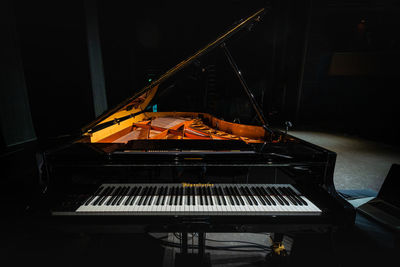 Low angle view of illuminated piano in building