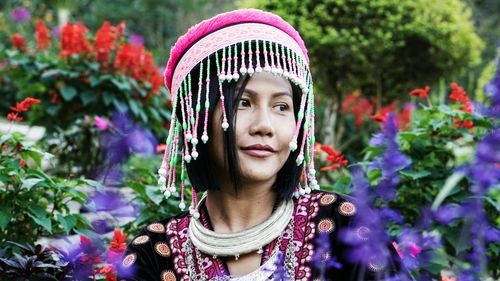 Portrait of beautiful young woman with flowers