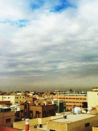 Buildings against cloudy sky