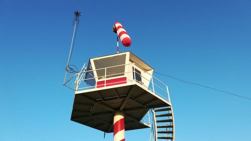 Low angle view of lighthouse against blue sky