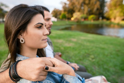 Portrait of young woman sitting on field