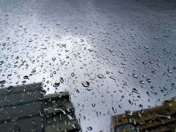 High angle view of rain drops on glass