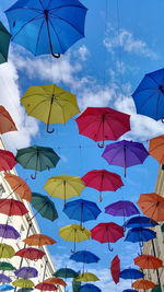 Low angle view of colorful umbrellas against sky