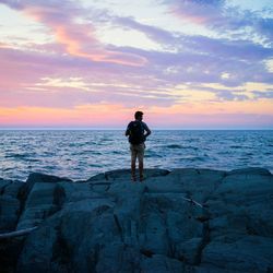 Silhouette of people on beach at sunset