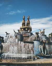 Statue of fountain against cloudy sky