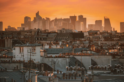 Buildings in city during sunset