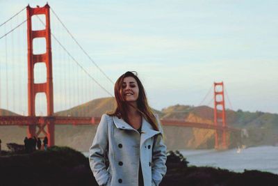 Portrait of young woman at suspension bridge