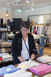 Senior woman doing shopping in clothes shop