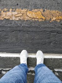Low section of man standing on floor