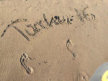 Text written on sand at beach