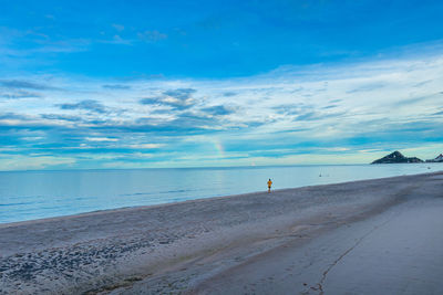 Scenic view of beach against blue sky