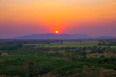 Scenic view of field against sky during sunset