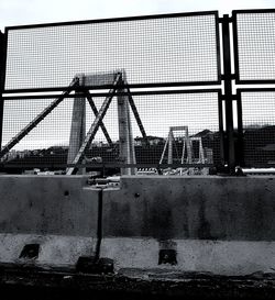 Metal bridge against sky in city