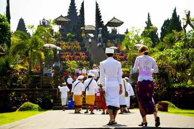 Rear view of people walking outdoors