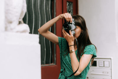 Young woman photographing camera