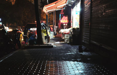 Man walking on illuminated city at night