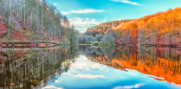 Reflection of trees in lake against sky during autumn