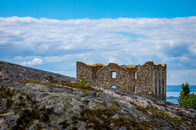 Low angle view of fort against cloudy sky