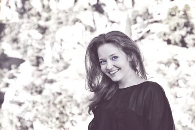 Portrait of a smiling young woman standing outdoors