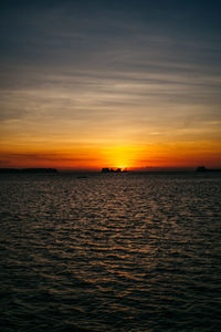 Scenic view of sea against romantic sky at sunset