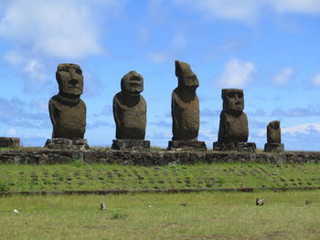 Old ruins on field against cloudy sky