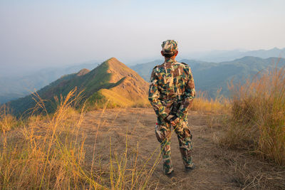 Rear view of man standing on mountain