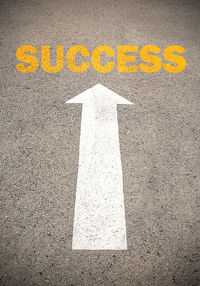 High angle view of arrow sign on road in city