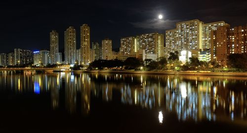 Reflection of illuminated buildings in city at night